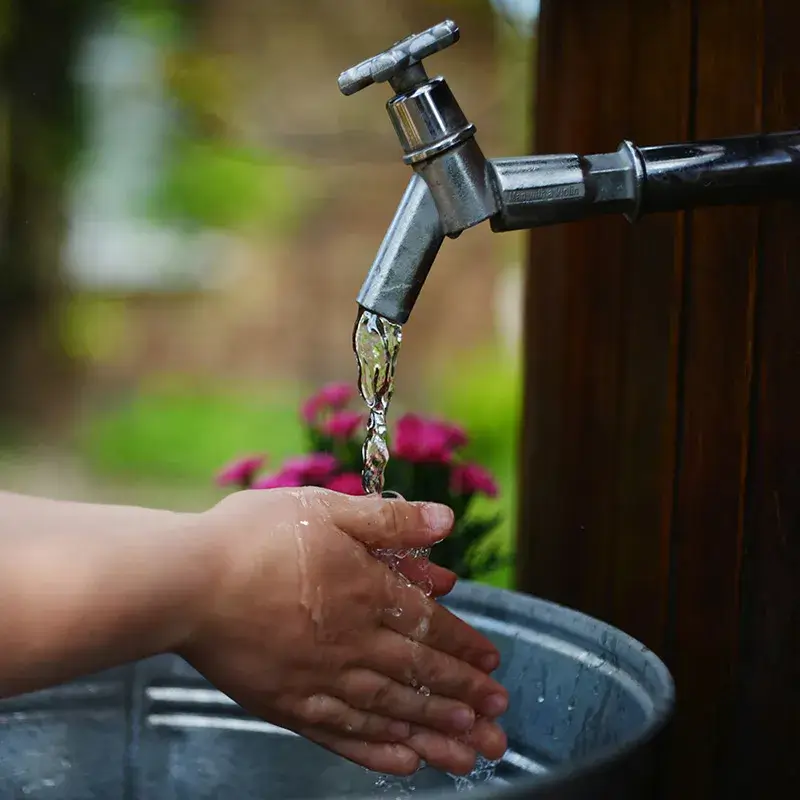 Washing hands with outdoor water faucet