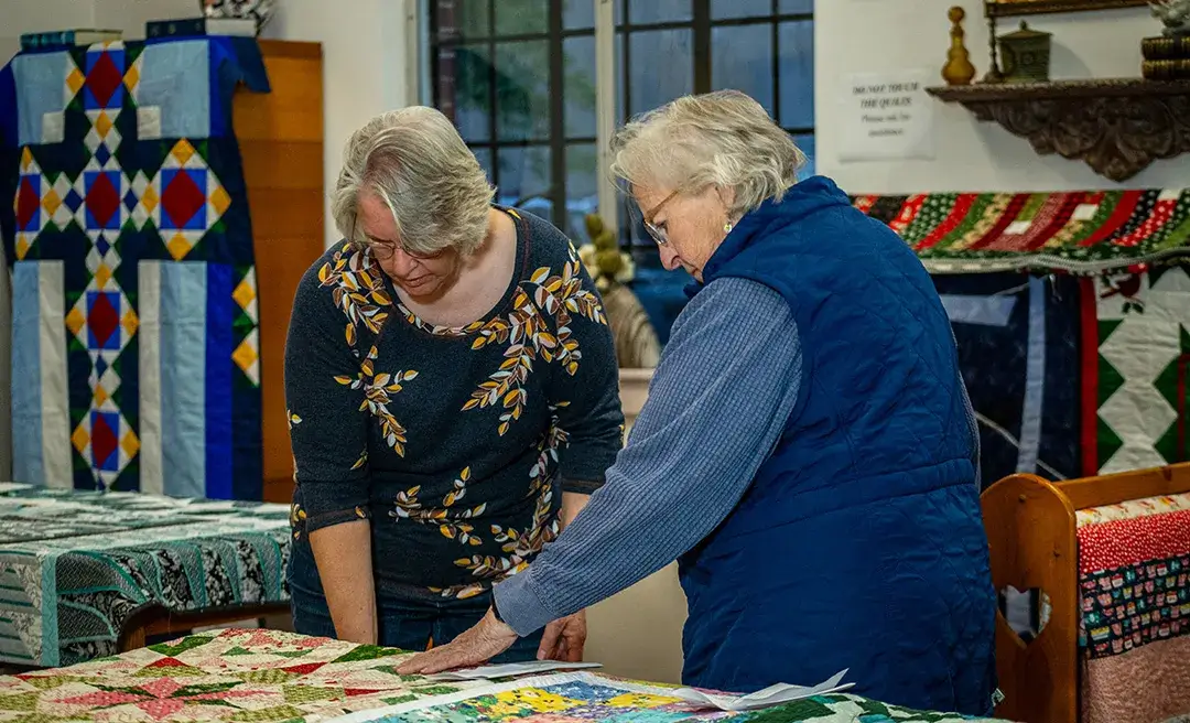 Festival judges looking at quilts