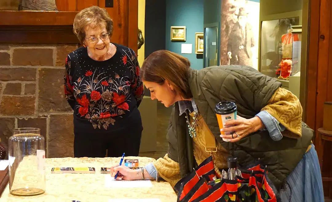 Woman signing up for event at museum
